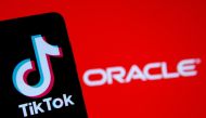 A smartphone with the Tik Tok logo is seen in front of a displayed Oracle logo in this illustration taken, Septemeber 14, 2020. REUTERS/Dado Ruvic/Illustration