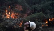 Johnny Islas, a firefighter from Las Vegas, monitors ambers from a firing operation near the Obenchain Fire in Butte Falls, Oregon, U.S., September 15, 2020. REUTERS/Adrees Latif