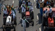 Farmers on tractors shout slogans as they arrive to block the Delhi-Uttar Pradesh border during a protest against farm bills passed by India's parliament, in Noida, India, September 25, 2020. REUTERS/Danish Siddiqui

