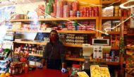 An employee wearing a face mask waits for customers behind a plastic curtain in a food shop at the Vallecas neighbourhood, amid the coronavirus disease (COVID 19) outbreak in Madrid, Spain, September 25, 2020. Reuters/Sergio Perez