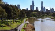 People exercise along the banks of the Yarra River in Melbourne on September 27, 2020 as an overnight curfew in Australia's second-biggest city will be lifted from September 28, almost two months after it was imposed to counter a surging COVID-19 coronavi
