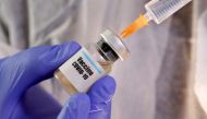 FILE PHOTO: A woman holds a small bottle labeled with a 