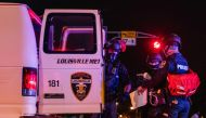 LOUISVILLE, KY - SEPTEMBER 26: Police officers put a protestor in the back of a police vehicle on September 26, 2020 in Louisville, Kentucky. Mayor Greg Fischer mandated a city-wide curfew restricting protestors from gathering between the hours of 9 p.m. 