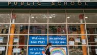 A pedestrian walks past Public School 41 following the outbreak of the coronavirus disease (COVID-19) in the Manhattan borough of New York City, New York, U.S., September 27, 2020. REUTERS/Jeenah Moon
