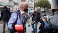 Britain's Prime Minister Boris Johnson wears a protective face covering as he arrives at the BBC in central London on October 4, 2020, to take part in the BBC political programme The Andrew Marr Show. AFP / JUSTIN TALLIS
