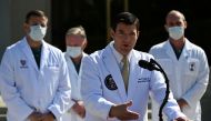 U.S. Navy Commander Dr. Sean Conley, the White House physician, is flanked by other doctors as he speaks to the media about U.S. President Donald Trump's health after the president was hospitalized for the coronavirus disease (COVID-19) treatment, at Walt