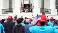 US President Donald Trump speak about law and order to supporters from the South Portico of the White House in Washington, DC, on October 10, 2020. Trump spoke publicly for the first time since testing positive for Covid-19, as he prepares a rapid return 