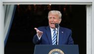 US President Donald Trump stands on a White House balcony speaking to supporters gathered on the South Lawn for a campaign rally that the White House is calling a 
