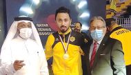 Qatar SC's Ahmed Khalil Al Mohannadi posing for a photograph with the Ambassador of Peru to Qatar, H E Jose Benzaquen, and the President of the Qatar Table Tennis Association, Khalil Al Mohannadi (left) after winning the Amir Cup on Monday.