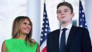(FILES) In this file photo taken on August 27, 2020, US First Lady Melania Trump (L) looks at her son Barron Trump after US President Donald Trump delivered his acceptance speech for the Republican presidential nomination on the South Lawn of the White Ho