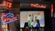 A commercial poster showing K-pop group BTS members is reflected in a mirror at a duty free shop in Seoul on October 15, 2020. / AFP / Jung Yeon-je