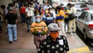 FILE PHOTO: People walk on a street in Guayaquil, Ecuador, in May, amid the outbreak of the coronavirus disease (COVID-19), May 20, 2020. REUTERS/Vicente Gaibor del Pino/File Photo
