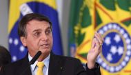 Brazilian President Jair Bolsonaro gestures during an event to announce the clinical study of the use of Nitazoxanide in an early treatment against COVID-19 at Planalto Palace in Brasilia, on October 19, 2020. / AFP / EVARISTO SA
