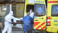 Dutch health workers leave with a patient at Bernhoven hospital, as the spread of coronavirus disease (COVID-19) continues, in Uden, Netherlands, March 25, 2020. REUTERS/Piroschka van de Wouw/File Photo