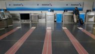FILE PHOTO: A lone customer seeks assistance at an American Airlines check-in counter at Washington's Reagan National airport as the novel coronavirus (COVID-19) pandemic continues, in Washington, U.S. April 29, 2020. REUTERS/Kevin Lamarque/File Photo