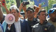 Venezuelan opposition leader and self-proclaimed acting president Juan Guaido (L) speaks to supporters next to high-profile opposition politician Leopoldo Lopez (R),  AFP / Federico PARRA