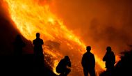 Residents are silhouetted as they watch the Blue Ridge Fire burning in Yorba Linda, California, U.S. October 26, 2020. REUTERS/Ringo Chiu