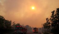 Fire trucks arrive as the Silverado Fire approaches, near Irvine, California, U.S. October 26, 2020. REUTERS/Mike Blake
