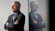 FILE PHOTO: National Institute of Allergy and Infectious Diseases Director Dr. Anthony Fauci is reflected in a video monitor behind him on stage as he listens to the daily coronavirus task force briefing at the White House in Washington, U.S., April 8, 20