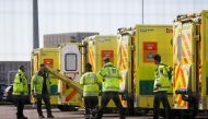 FILE PHOTO: Paramedics and ambulances are seen outside the Excel Centre, London while it is being prepared to become the NHS Nightingale Hospital, as the spread of the coronavirus disease (COVID-19) continues, London, Britain, April 1, 2020. REUTERS/Henry