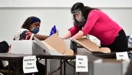 Boxes of ballots are opened up to be counted at the Los Angeles County Regional Offices in Downey, California on November 3, 2020, after voting for the 2020 US Elections closed. / AFP / Frederic J. BROWN