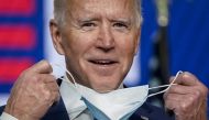 Democratic presidential nominee Joe Biden takes his face mask off as he arrives to speak one day after America voted in the presidential election, on November 04, 2020 in Wilmington, Delaware. Biden spoke as votes are still being counted in his tight race