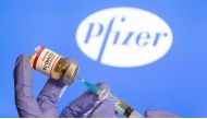 FILE PHOTO: A woman holds a small bottle labeled with a 