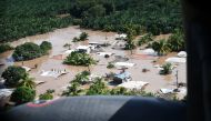 Hondurans stand on rooftops surrounded by the floodwaters of Hurricane Eta in San Pedro Sula, Honduras, November 7, 2020. Picture taken November 7, 2020. U.S. Air Force/Staff Sgt. Elijaih Tiggs/Handout via REUTERS. THIS IMAGE HAS BEEN SUPPLIED BY A THIRD 