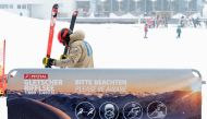 A skier prepares his skis next to the covid-19 safety instruction sign at Pitztal glacier, Austria on October 29, 2020. After some of its economically crucial ski resorts became bywords for coronavirus clusters in the first wave of the pandemic, Austria w