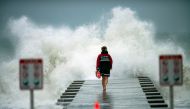 A lifeguard walks to the end of the jetty after closing it down to surfers before the arrival of Tropical Storm Eta in Bradenton Beach, Florida, U.S. November 11, 2020. REUTERS/Steve Nesius
