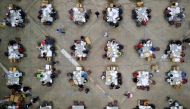 Electoral workers count votes from briefcases with uncounted ballots for the election of local leaders in a tabulation center at the Roberto Clemente Coliseum in San Juan, Puerto Rico, November 11, 2020. Officials said over 180 briefcases were discovered 