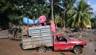 Workers of banana fields evacuate the area in El Progreso, Yoro department, Honduras, on November 14, 2020, before the arrival of tropical storm Iota. Less than two weeks after powerful storm Eta killed more than 200 people across Central America, authori