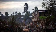 A dog eats from the rubble of houses destroyed by the passage of Hurricane Eta, in Bilwi, Puerto Cabezas, Nicaragua, on November 15, 2020, before the arrival of Hurricane Iota. AFP / STR