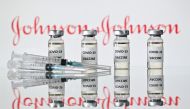An illustration picture shows vials with Covid-19 Vaccine stickers attached and syringes with the logo of US pharmaceutical company Johnson & Johnson on November 17, 2020. / AFP / JUSTIN TALLIS
