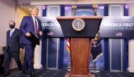 U.S. President Donald Trump is followed by Health and Human Services (HHS) Secretary Alex Azar as he arrives to speak about prescription drug prices in the Brady Press Briefing Room at the White House in Washington, U.S., November 20, 2020. REUTERS/Carlos