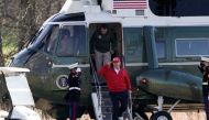 US President Donald Trump walks out of Marine One along with Donald Trump Jr, at Trump National Golf Club in Sterling, Virginia, U.S., November 28, 2020. REUTERS/Ken Cedeno