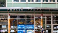 FILE PHOTO: A pedestrian walks past Public School 41 following the outbreak of the coronavirus disease (COVID-19) in the Manhattan borough of New York City, New York, U.S., September 27, 2020. REUTERS/Jeenah Moon/File Photo
