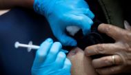 A man receives the first of two Pfizer/BioNTech COVID-19 vaccine jabs, at Guy's Hospital, at the start of the largest-ever immunisation programme in British history, in London, Britain December 8, 2020. Victoria Jones/Pool via Reuters/File Photo