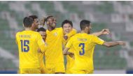 Al Gharafa players celebrate after defeating Al Ahli yesterday.