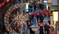 People with protective face masks walk beside Christmas themed lights at Schloss Strasse shopping street, amid the coronavirus disease (COVID-19) outbreak in Berlin, Germany, December 10, 2020. REUTERS/Fabrizio Bensch
