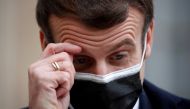 French President Emmanuel Macron, wearing a protective face mask, scratches his brow as he talks to the media next to Portugal's Prime Minister Antonio Costa (not seen) before a meeting at the Elysee Palace in Paris, France, December 16, 2020. REUTERS/Gon