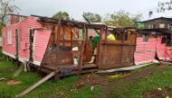 A man works on a damaged house in the aftermath of Cyclone Yasa in Nasavu, Bua Province, Fiji December 18, 2020, in this image obtained from social media. Miriama Nakauvadra/via Reuters 