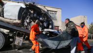 Municipal workers clean up debris at the site of a bomb attack in Kabul on December 22, 2020. AFP / Zakeria Hashimi 