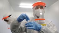 FILE PHOTO: A health care worker collects a swab sample during a voluntary rapid antigen testing campaign for the coronavirus disease (COVID-19) at a hospital in Prague, Czech Republic, December 16, 2020. REUTERS/David W Cerny/File Photo