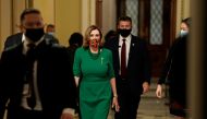 FILE PHOTO: Speaker of the House Nancy Pelosi (D-CA), walks from the Senate floor as both chambers of Congress are aimed to pass the coronavirus disease (COVID-19) package in a marathon session on Capitol Hill Washington, D.C., U.S., December 21, 2020. RE