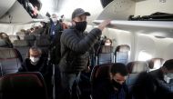 FILE PHOTO: People depart a Boeing 737 Max airplane at Dallas Fort Worth Airport following a media flight to Tulsa, Oklahoma, in Dallas, Texas, U.S., December 2, 2020. REUTERS/Carlo Allegri