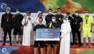 Qatar Olympic Committee (QOC) Secretary-General Jassim Rashid Al Buenain presenting the award to the winners of the beach football tournament, Al Shahaniya team members on the final day of the QOC Beach Games at Aspire Zone yesterday.