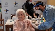 An elderly woman claps her hands after receiving a vaccine against the coronavirus disease (COVID-19) at a nursing home in Athens, Greece, January 4, 2021. Louisa Gouliamaki/Pool via REUTERS
