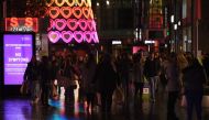 Pedestrians walk through central Liverpool, northwest England, on December 30, 2020 before thightened Tier 3 restrictions imposed in the city amid surging cases of the novel coronavirus. / AFP / Oli SCARFF
