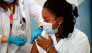 Jennifer Arce, worker of the Amavir nursing home, receives an injection with a dose of the Pfizer-BioNTech COVID-19 vaccine, as the coronavirus disease (COVID-19) outbreak continues, in Madrid, Spain, December 30, 2020. REUTERS/Juan Medina

